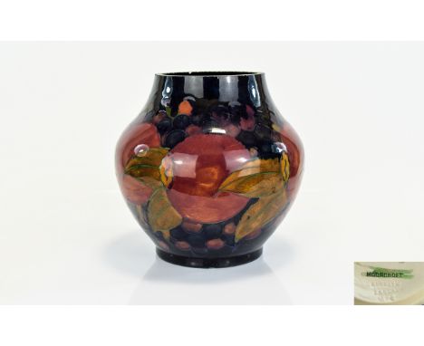 William Moorcroft Signed Globular Shaped Vase ' Pomegranates and Berries ' Design on Blue Ground. c.1920's. Signed In Green I