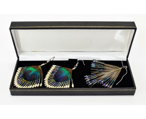 A Pair Of Unique And Intricate Handmade Peacock Feather Earrings Attractive wired drop earrings fashioned from the eye of pea