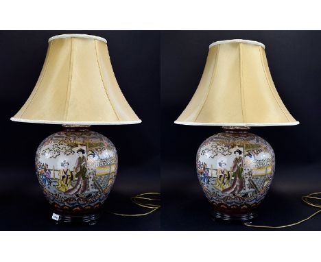 A Pair Of Large And Ornate Oriental Ceramic Table Lamps Two in total, each with pale gold textured silk bell canopy shades. T