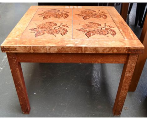 A Mebler Danish coffee table with four ceramic tiles of leaf design inlaid in the top (af)the