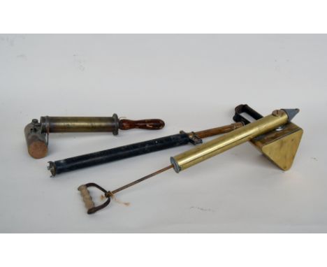 Two vintage brass garden sprays and a brass water pump