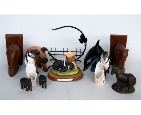 An assorted selection of animal figurines, including a Poole pottery dolphin, a matching pair of Goebel birds and a pair of e