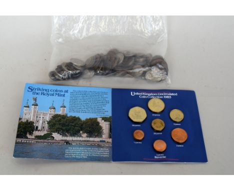 A selection of vintage coins including Nazi era German coins and an uncirculated coin collection from 1983