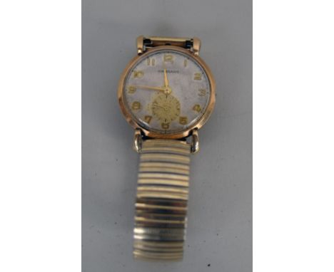An early 20th century gentleman's Garrard presentation wrist watch, with a 9ct gold case with gold Arabic numerals on a white