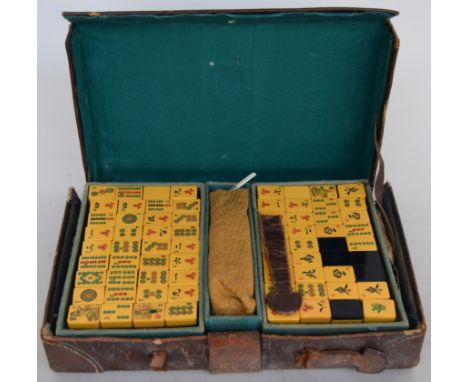 A vintage Mahjong set with counters, instructions and score sheet, in a leather case