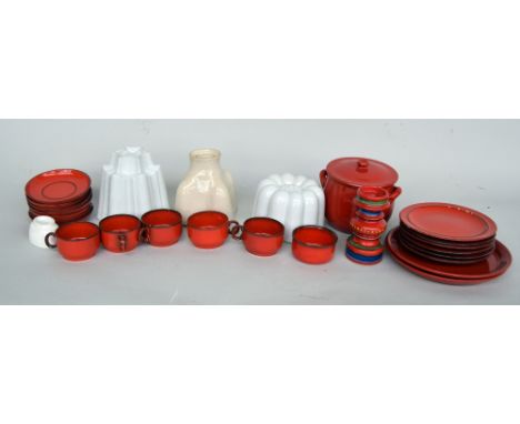 A part service of plain red glazed pottery by Thomas, including saucers, plates and teacups, together with a casserole pot an