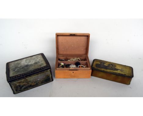 A quantity of vintage costume jewellery, mostly brooches and necklaces, in a carved wooden box, together with two vintage tin