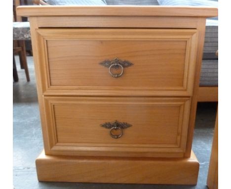 A pine bedside cabinet with two drawers with metal ring handles and on a square base, 45 x 40 x 48cmH
