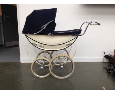 A vintage Royale coachbuilt doll's pram with cream body and navy upholstery, 91cmH