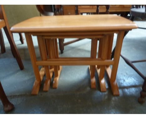 An Ercol nest of three tables, the largest measuring 62 x 39 x 42cmH