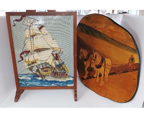 A VINTAGE FIREGUARD WITH AN EMBROIDERED FIGHTING SHIP &amp; A CARVED WORKING HORSE PLAQUE