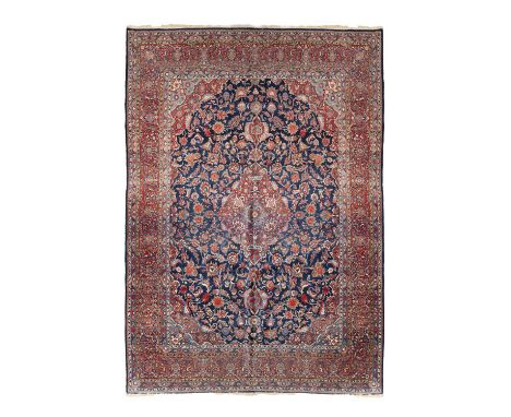 AN ANTIQUE KASHAN CARPET,hand knotted in the city of Kashan, Central Persia, c.1920-30, with a traditional centre pendant med