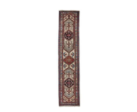 AN ANTIQUE SARAB RUNNER,hand knotted in the village district of Sarab, N.W. Persian Azerbaijan, c. 1900-1920, with two oblong