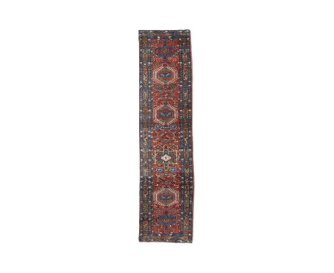 AN ANTIQUE KARADJA RUNNER,hand knotted in the village district of Karadja, NW Persian Azerbaijan, c. 1910-1925, the field wit