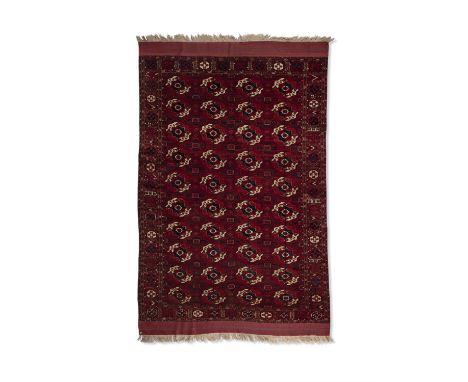 A FINE ANTIQUE TEKKE CARPET,hand knotted by nomadic Tekke Turkoman weavers, southern Turkmenistan, probably c.1820, with four