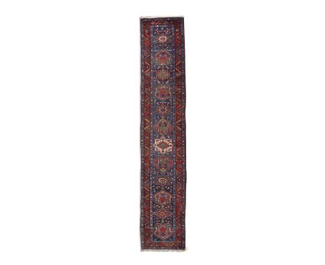 AN ANTIQUE HERIZ RUNNER,hand knotted in the village region between Heriz and Karadja, NW Persia, c. 1900-1925, the field with