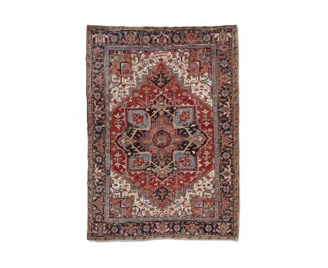 AN ANTIQUE HERIZ CARPET,hand knotted in the Heriz village district, N.W. Persia, c.1900-20, with a large octofoil centre meda