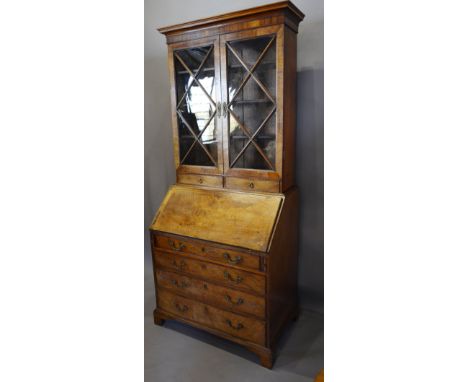 A George III Mahogany Line and Marquetry Inlaid Bureau Bookcase, the moulded cornice above two astragal glazed doors enclosin