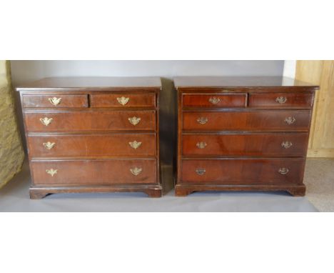 A Pair of Reproduction Mahogany Chests, the crossbanded moulded tops above two short and three long drawers with brass handle
