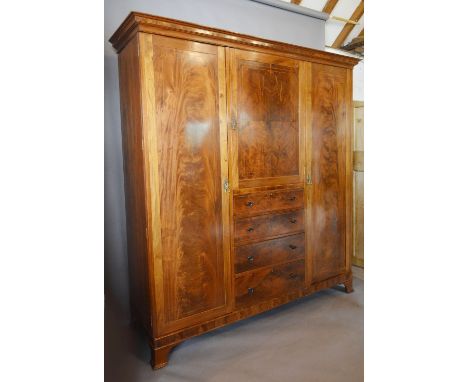An Edwardian Mahogany Line Inlaid Wardrobe by Maple & Co., the moulded cornice above a central door above four drawers with k