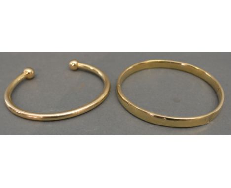 A 9ct. Gold Bangle, 23.2 gms, together with a 14ct. gold bangle, 7.3 gms