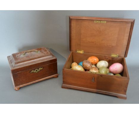 A 19th Century Mahogany Tea Caddy, together with a mahogany small box containing hand warmers in the form of eggs