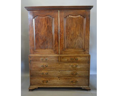 A George III Mahogany Press Cupboard converted to Hanging with a moulded cornice above two shaped moulded doors above two sho