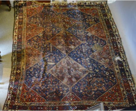 A North West Persian Woollen Carpet with three central medallions within a blue and red ground within multiple borders, 330 x