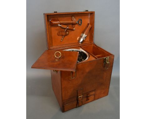 A Leather Champagne Hamper, the hinged cover enclosing a fitted interior with silver plated wine cooler and various accessori