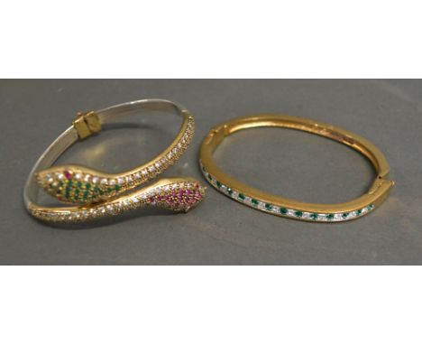 A Bangle in the form of Two Snake Heads, together with another similar stone set bangle