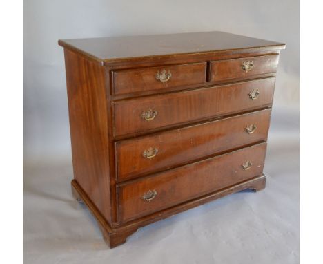 A Reproduction Mahogany Chest, the crossbanded and moulded top above two short and three long drawers with brass handles rais
