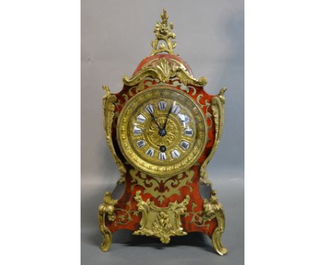 A French Boulle Gilt Metal Mounted Time Piece, the brass dial with ceramic tablet Roman numerals and single train movement, 3