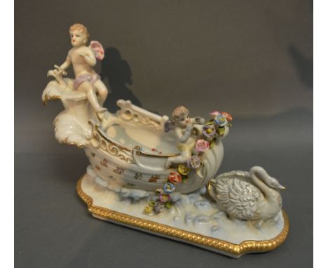 A German Porcelain Vase in the form of a Chariot mounted with Putti and Swan, 20 cms tall