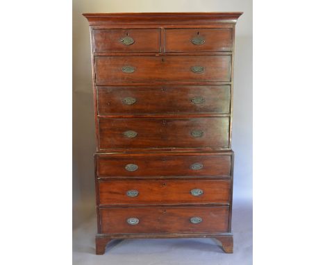 A George III Mahogany Chest on Chest, the moulded cornice above two short and six graduated drawers with oval brass handles, 