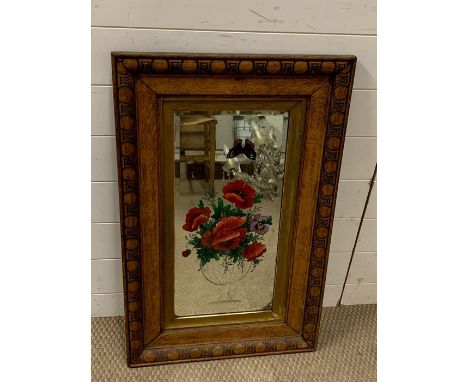 A screen printed mirror set in a mahogany frame 