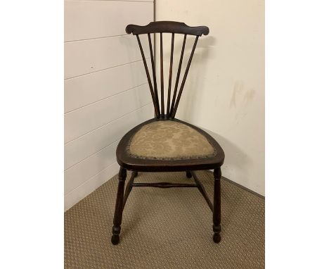 An Oak stick back chair on triangle form seat.