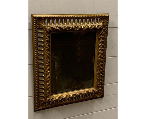 A gilt framed foxed wall mirror (37cm x 32cm)