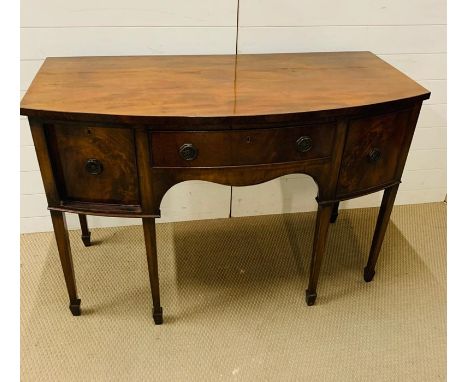 A Bow Front sideboard with arch knee hole centre drawer flanked by deep cupboards to sides( H 90 cm x D 59 cm x W 130 cm)