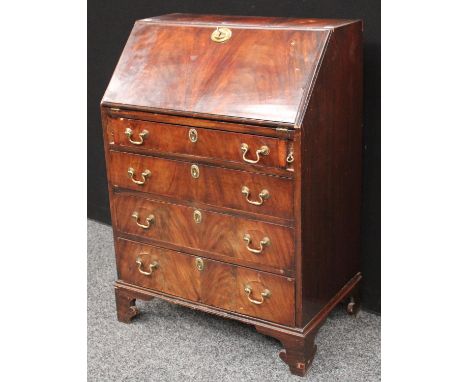 A George III style bureau, of small proportions, fall front enclosing small drawers and pigeonholes, above four long graduate