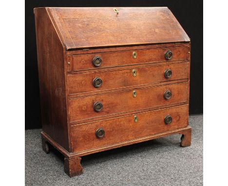 A George III oak bureau, fall front enclosing a small door, small drawers and pigeonholes, above four long graduated cockbead