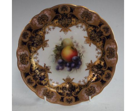 An early 20th century Royal Worcester shaped circular cabinet plate, the central painted with fruit, signed F. Sebright, 22.5