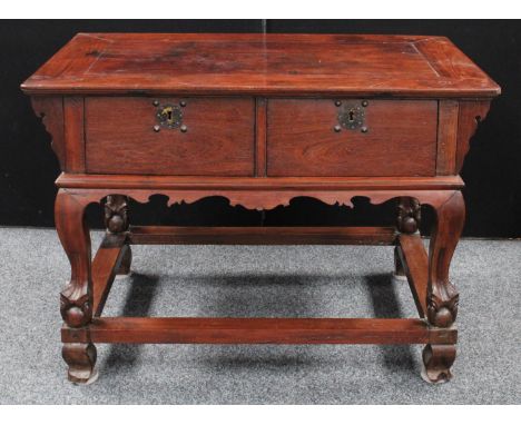 A substantial Chinese hardwood centre table, rectangular panel top above a pair of deep drawers, shaped apron, square section