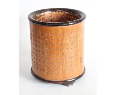 A Chinese two-tone bamboo bitong brush pot, profusely carved in shallow relief with script, bracket feet, 15.5cm, six-charact