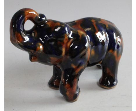 An early/mid 20th century Denby Majolica piggy bank as an Elephant, trunk raised
