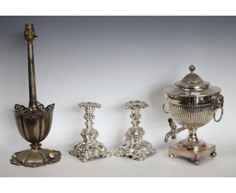 A 19th century Sheffield plated urn, bearing armorial; a pair of ornate silver plated candlesticks; an Elkington table lamp