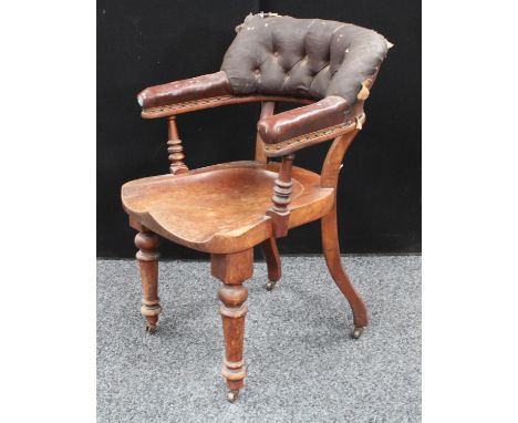 A Victorian club/tub type desk chair, curved button back, saddle seat, turned forelegs, serpentine rear legs, 89cm high