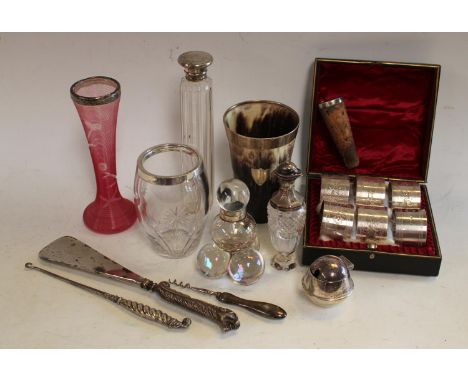 An Edwardian silver mounted beaker, Birmingham 1904; silver mounted scent bottles; a set of six silver plated numbered napkin