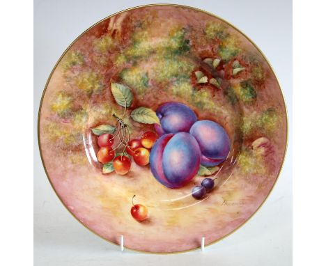 A Royal Worcester circular plate, painted by John Freeman, signed, with plums and cherries, on a mossy ground, 26.5cm diamete
