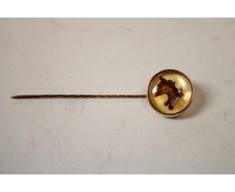 An Elizabeth II 9ct gold-mounted Essex rock crystal gentleman's novelty stick pin, inset with a sporting roundel of a race ho