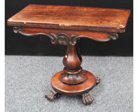 A William IV rosewood card table, rounded rectangular folding top enclosing a circular baize lined playing surface, above a s